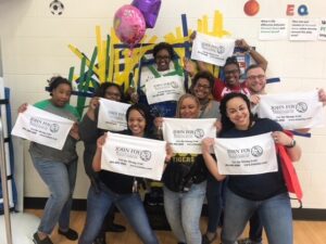 DJ Reec of Hot 107.9 Teams Up with John Foy & Associates to Get Students Hyped Up for State Testing Teachers holding Armstrong Banners