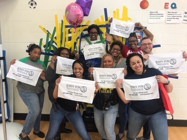 DJ Reec of Hot 107.9 Teams Up with John Foy & Associates to Get Students Hyped Up for State Testing Teachers holding Armstrong Banners