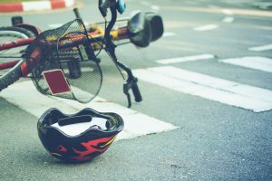 helmet and bicycle lying in crosswalk