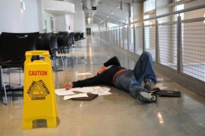 Slip and Fall Lawyer in Hampton, GA | John Foy & Associates A man lies injured after falling on a wet floor.