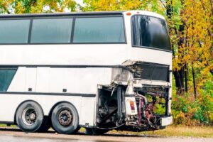 Bus Accident Lawyer in Sandy Springs | John Foy & Associates A damaged bus sits on the road after a crash.