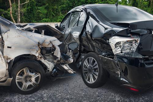 PHOTOS: Driver charged after box truck smashes into car dealership