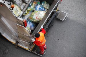 Columbus Garbage Truck Accident Lawyers | John Foy & Associates garbage truck driving on highway
