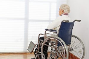 lonely elderly woman in wheelchair
