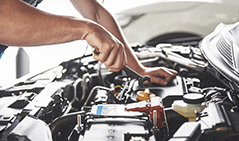 muscular_car_service_worker_repairing_vehicle