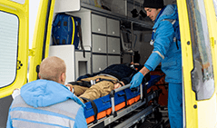paramedics_uniform_pushing_stretcher_with_fixed_unconscious_man_into_ambulance_car_get_him_hospital