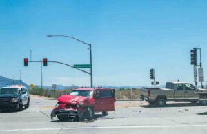 Mableton Red Light Accident Lawyers | Hablamos Español | 24/7 Support The aftermath of a car crash at an intersection. Two vehicles with severe damages.