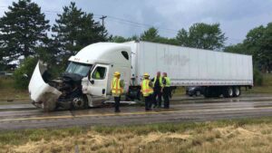 Mableton Cargo Truck Accident Lawyers | Free Case Reviews Available A red car is in ruins after crashing head-on into a larger cargo truck.