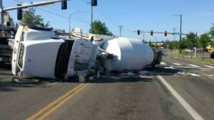 Mableton Construction Truck Accident Lawyers | Get Your Free Consultation A cement truck is getting hauled away after a crash near the freeway.