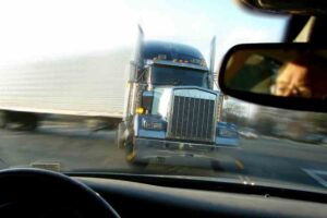 Mableton Tractor-Trailer Accident Lawyers | No Fees Unless We Win A tractor-trailer is about to hit another car from the point of view of the passenger vehicle.