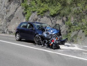 Athens Negligent Rider Accident Lawyer | Receive Your Free Case Review The aftermath of a motorcycle accident that occurred on the road. There is massive damage to the fronts of both vehicles.