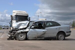 Athens Semi-Truck Accident Lawyer | No Upfront Fee | Free Consultations Severe damages on a car after a crash with a semi-truck on the road.