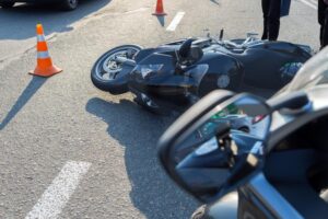 Columbus, GA, Motorcycle Accident Lawyer | Free Consultations downed motorcycle in front of car and traffic cones