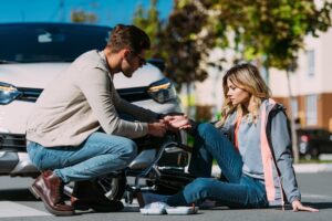 Douglasville Personal Injury Lawyers | John Foy & Associates Driver rushing to help an injured woman after a car accident