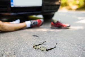 Glasses on the road after a car hits a pedestrian.
