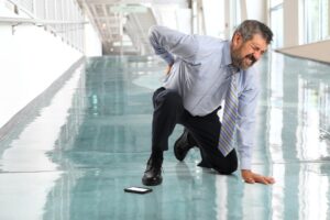 Personal Injury Lawyers in Smyrna - John Foy & Associates man grabs back after slipping and falling.