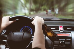 Marietta Drunk Driving Victim Accident Lawyer | 24/7 Support A person drinking while driving speeding down the street.
