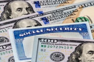 Alpharetta Social Security Disability Lawyer | John Foy & Associates Hundred dollar bills with a social security card in the middle.