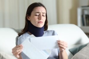 Catastrophic Injury Lawyer in Newnan | Get a Free Consultation An injured and disabled woman stressed over bills.