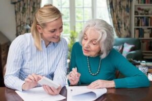 Social Security Disability Lawyer in Jonesboro, GA | John Foy An elderly woman gets help with paperwork.