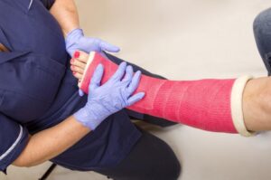 Catastrophic Injury Lawyer in Marietta | Free Consultations doctor treating a woman in a leg cast