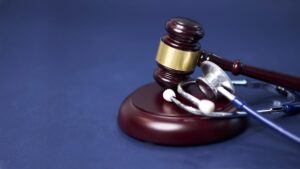Defective Medical Device Recall Lawyers | Available 24/7 gavel rests on stand with stethoscope