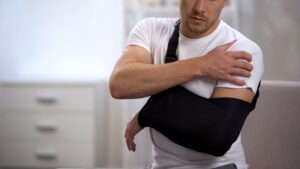 Motorcycle Accident Lawyer in Marietta | John Foy & Associates injured man in sling feels hurt shoulder
