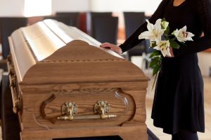 woman touching a coffin