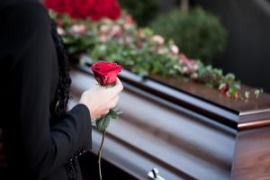 woman with a rose at a funeral