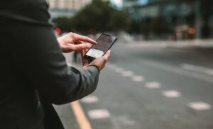 Lyft Accident Lawyer in Newnan | Free Consultations person checking a rideshare app