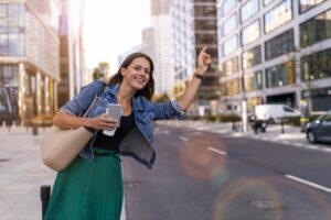 Uber Accident Lawyer in Griffin | Free Consultations woman hailing a rideshare car