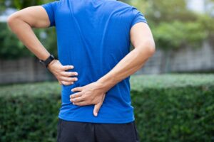 Augusta Back Injury Lawyers | John Foy & Associates | Call 24/7 man holding back in pain