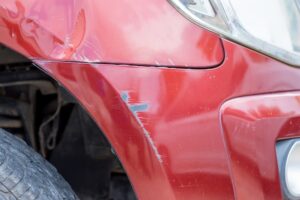 Lyft Accident Lawyer in Brookhaven | John Foy | Free Consults scratched red car