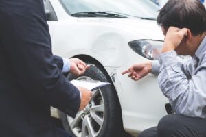 Tucker Rideshare Accident Lawyers | 24/7 Help insurance agent documenting accident