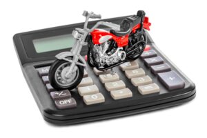 model motorcycle on top of calculator