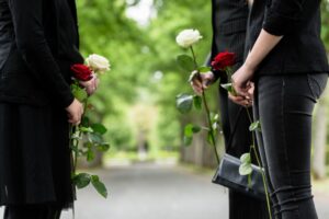 Riverdale Wrongful Death Lawyers | Free Consults mourners commiserating with flowers