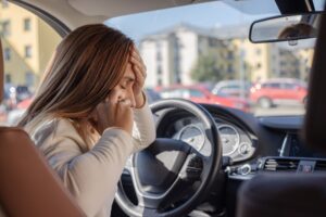 Rideshare Accident Lawyer in Stone Mountain woman calling for help after a car accident