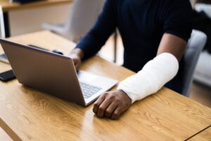 Workers’ Compensation Attorney in South Fulton injured black worker filling out workers’ comp form online
