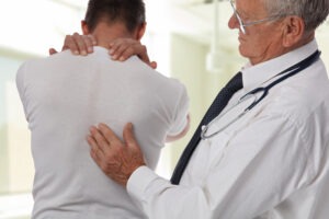 Back Injury Lawyer in Austell | Free Consultation doctor helping patient with back pain