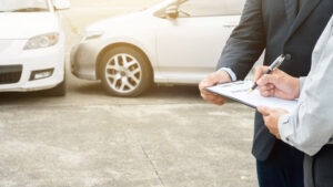 Rideshare Accident Lawyer in Austell | Free Consults insurance agent filling out accident paperwork
