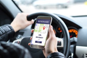 Lyft Accident Lawyer in Smyrna | Free Consultations rideshare driver using app