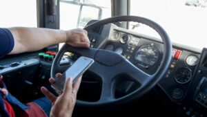 Bus Accident Lawyers in Carrollton | Free Consultations bus driver texting at the whee