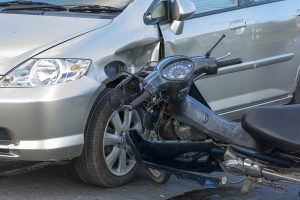 motorcycle crash into a silver sedan