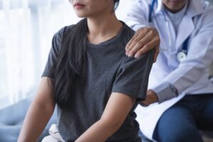 Back Injury Lawyer in East Point | Free Consults doctor helping patient with lower back pain