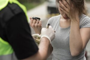 Drunk Driving Accident Lawyer in Evans | Free Consults female driver taking a breathalyzer
