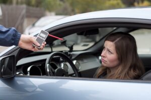 Drunk Driving Accident Lawyer in Fayetteville woman taking a breathalyzer test