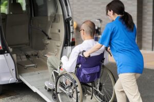 Catastrophic Injury Lawyer in Morrow | Free Consults caregiver loading man in a wheelchair on a van
