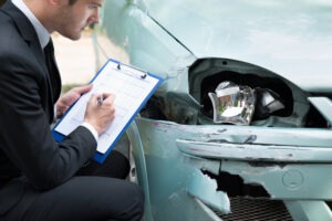 insurance-agent-with-clipboard-at-damage-site