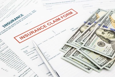 Insurance Claim Lawyer in Augusta | Free Consultation Insurance claim form with money scaled