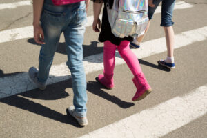 schoolchildren crossing road on their way to school